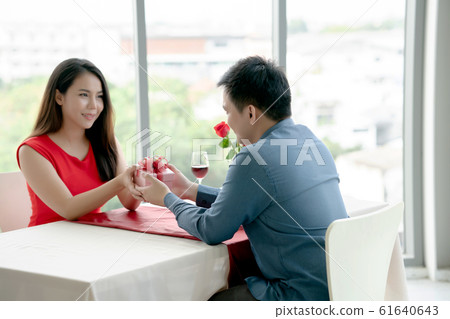 Girl receiving gift box, Valentive's day. 61640643