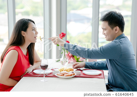 Happy man and woman have lunch in a restaurant, Happy man and woman have lunch in a restaurant, 61640645