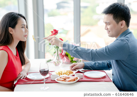 Happy man and woman have lunch in a restaurant Happy man and woman have lunch in a restaurant 61640646