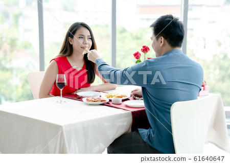 A pair of lovers, a man and a woman, eat french 61640647