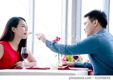 Happy man and woman have lunch in a restaurant 61640648