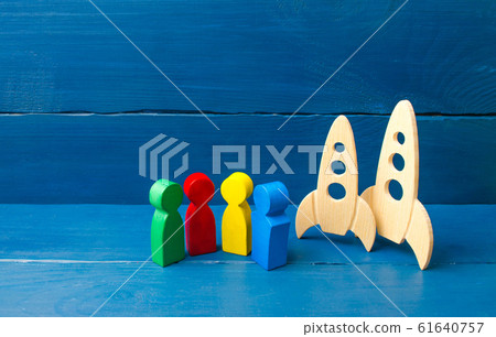 Multicolored figures of people are standing near missiles. The international scientific community. Cooperation and joint development of space technologies and expeditions. Flying into space. Multicolored figures of people are standing near missiles. The international scientific community. Cooperation and joint development of space technologies and expeditions. Flying into space. 61640757
