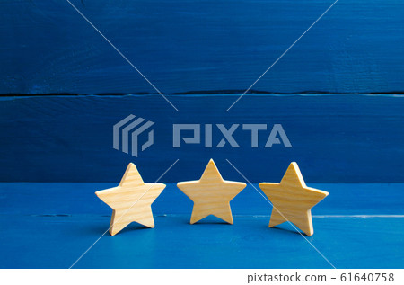 The concept of rating and evaluation. Quality service, buyer choice. Success in business The rating of the hotel, restaurant, mobile application. Three stars on a blue background. The concept of rating and evaluation. Quality service, buyer choice. Success in business The rating of the hotel, restaurant, mobile application. Three stars on a blue background. 61640758