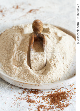 Teff flour in a plate with a spoon 61640873