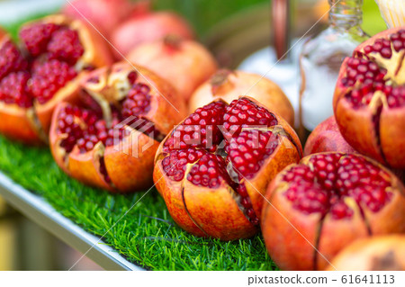 Ripe pomegranate fruit cut on the table of a Ripe pomegranate fruit cut on the table of a 61641113