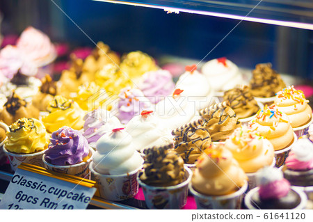 mini cakes in a refrigerated display case of a mini cakes in a refrigerated display case of a 61641120