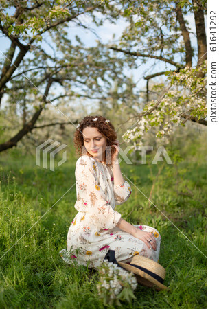 A gorgeous girl walks in a flowering spring 61641292