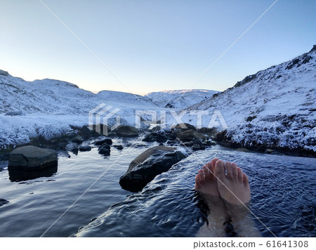 The girl lies in a hot spring in the open air with The girl lies in a hot spring in the open air with 61641308