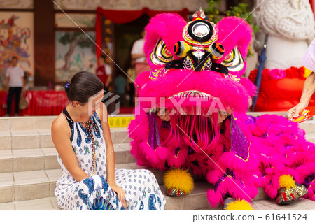 A European tourist girl at a Chinese New Year A European tourist girl at a Chinese New Year 61641524