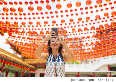 A tourist girl photographs the festive New Year A tourist girl photographs the festive New Year 61641525