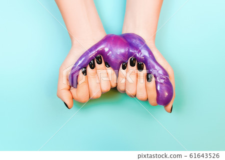 hands with holding slime in purple color hands with holding slime in purple color 61643526