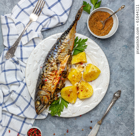 Baked mackerel with boiled potatoes. Baked mackerel with boiled potatoes. 61644111