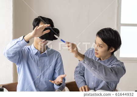 Two men who experience 3D with the latest 5G technology with VR goggles and incorporate it into architectural design 61644932