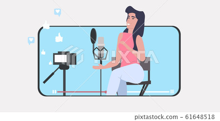 woman blogger recording music video vlog using digital camera on tripod podcasting broadcasting live streaming concept girl singing to microphone smartphone screen mobile app horizontal woman blogger recording music video vlog using digital camera on tripod podcasting broadcasting live streaming concept girl singing to microphone smartphone screen mobile app horizontal 61648518