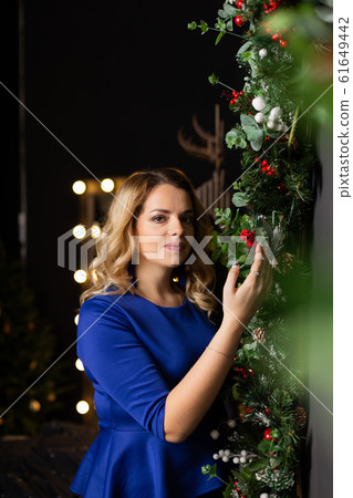 Beautiful woman with in a New Year s interior Beautiful woman with in a New Year s interior 61649442