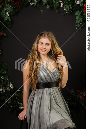 Girl in New Year's decor and a beautiful dress. 61651372