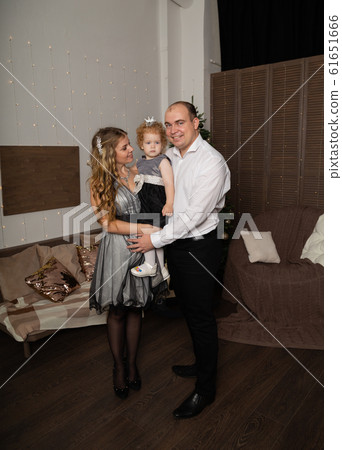 Beautiful young happy family with a child in her 61651666