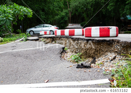 The road in the outdoor public parking lot collapsed,road collapses,cracked asphalt road and fallen,erosion of water,bad construction or earthquake The road in the outdoor public parking lot collapsed,road collapses,cracked asphalt road and fallen,erosion of water,bad construction or earthquake 61653182