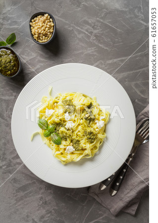 Pasta tagliatelle with pesto, pine nuts, chesse Pasta tagliatelle with pesto, pine nuts, chesse 61657053