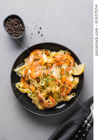 Pasta reginelle with seafood, shrimps, mussels Pasta reginelle with seafood, shrimps, mussels 61657054