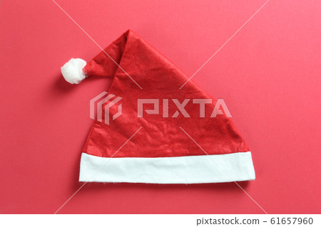 Santa hat on red art paper background. 61657960