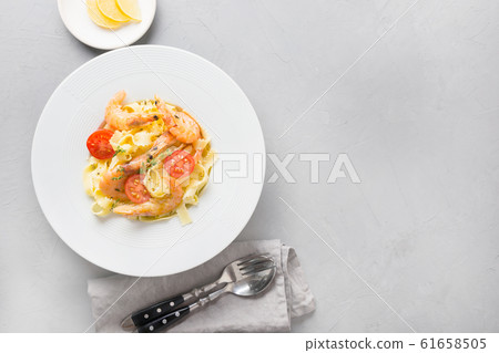 Pasta reginelle with seafood, shrimps on gray Pasta reginelle with seafood, shrimps on gray 61658505