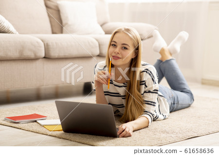 Pretty Girl Studying at Home, Using Laptop Pretty Girl Studying at Home, Using Laptop 61658636
