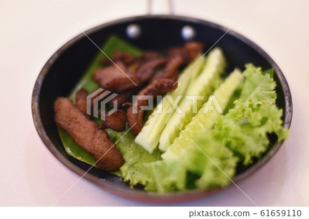 Sun-dried pork fried with vegetable in pan Sun-dried pork fried with vegetable in pan 61659110