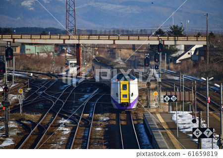 Photographing the scenery of the super express Hokuto, an express train that arrives and departs from Omanabane Station in Omanbe-cho, Hokkaido in winter 61659819