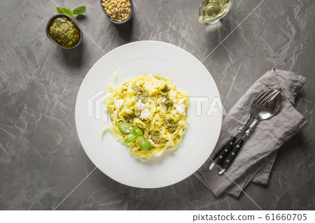 Pasta tagliatelle with pesto, pine nuts. Pasta tagliatelle with pesto, pine nuts. 61660705