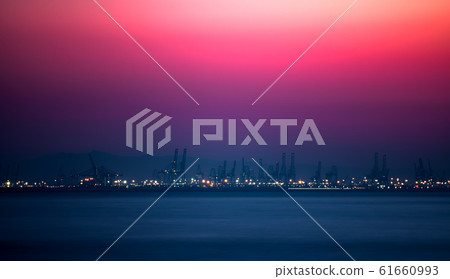 Pink sky over the commercial dock with cranes 61660993