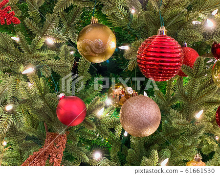 Red and gold decoration on the Christmas tree.  61661530