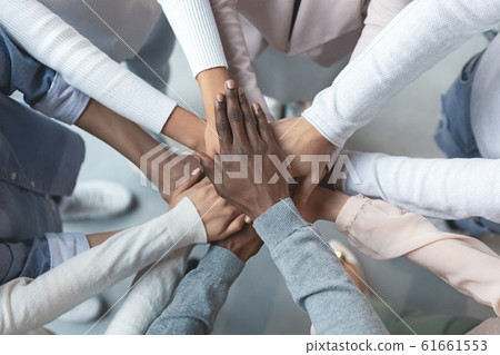 International business team putting hands together in cooperation 61661553
