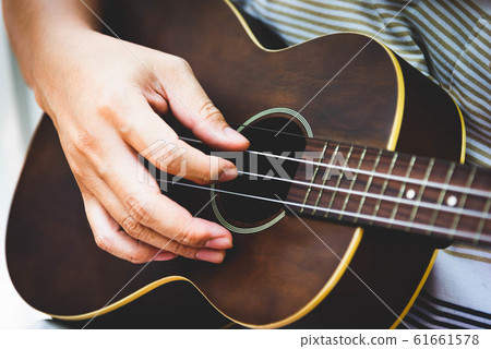 Closeup of guitarist hand playing guitar. Musical 61661578