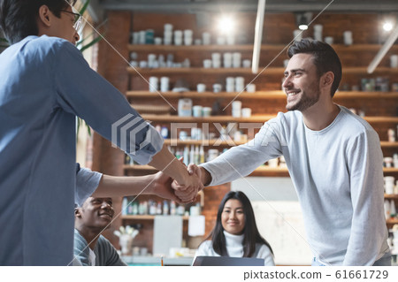 Close up of two guys colleagues shaking hands Close up of two guys colleagues shaking hands 61661729