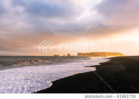 Incredible sunset light and large waves on Black beach 61661730