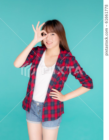 Beautiful happy young asian woman wear travel summer gesture ok sign 61661778