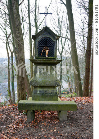 Typical old Christian wayside shrine at a country little forest  61661791