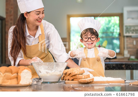 Cute little Asian boy and beautiful mother sifting 61661798