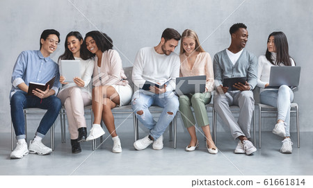 Young cheerful international people waiting for job interview Young cheerful international people waiting for job interview 61661814