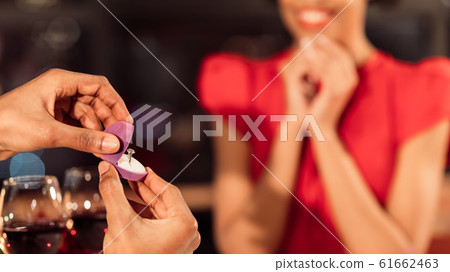 Unrecognizable Boyfriend Showing Engagement Ring To Girlfriend In Restaurant, Panorama Unrecognizable Boyfriend Showing Engagement Ring To Girlfriend In Restaurant, Panorama 61662463