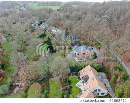 Aerial view of big villas with garden surrounded by forest during winte season 61662711