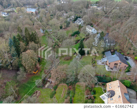 Aerial view of big villas with garden surrounded by forest during winte season 61662742