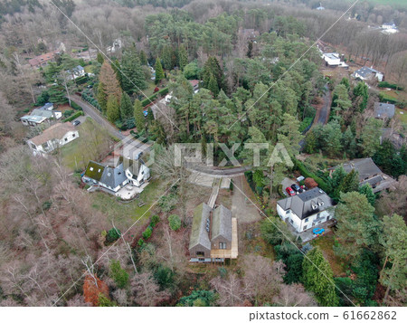 Aerial view of big villas with garden surrounded by forest during winte season 61662862