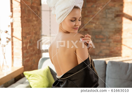Beauty Day. Woman doing her daily skincare routine at home 61663010