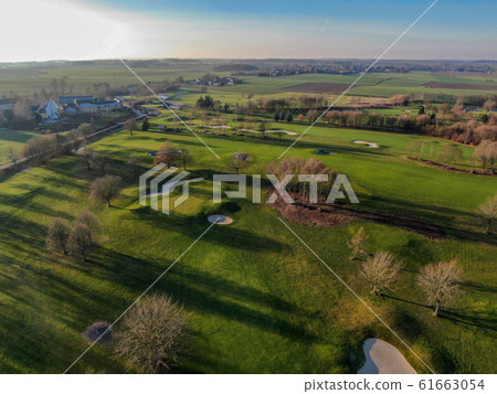 Aerial view of a golf course during autumn season Aerial view of a golf course during autumn season 61663054