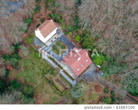 Aerial view of big villas with garden surrounded by forest during winte season 61663100
