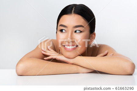 Beauty concept. Happy asian girl relaxing after cosmetology treatment Beauty concept. Happy asian girl relaxing after cosmetology treatment 61663290
