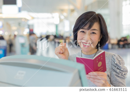 First boarding procedure Emotional and emotional scene of a middle woman who is going to issue a ticket 61663511