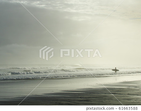 A young man surfing alone in the rough sea approaching the typhoon at Shiomizaka Beach 61663588